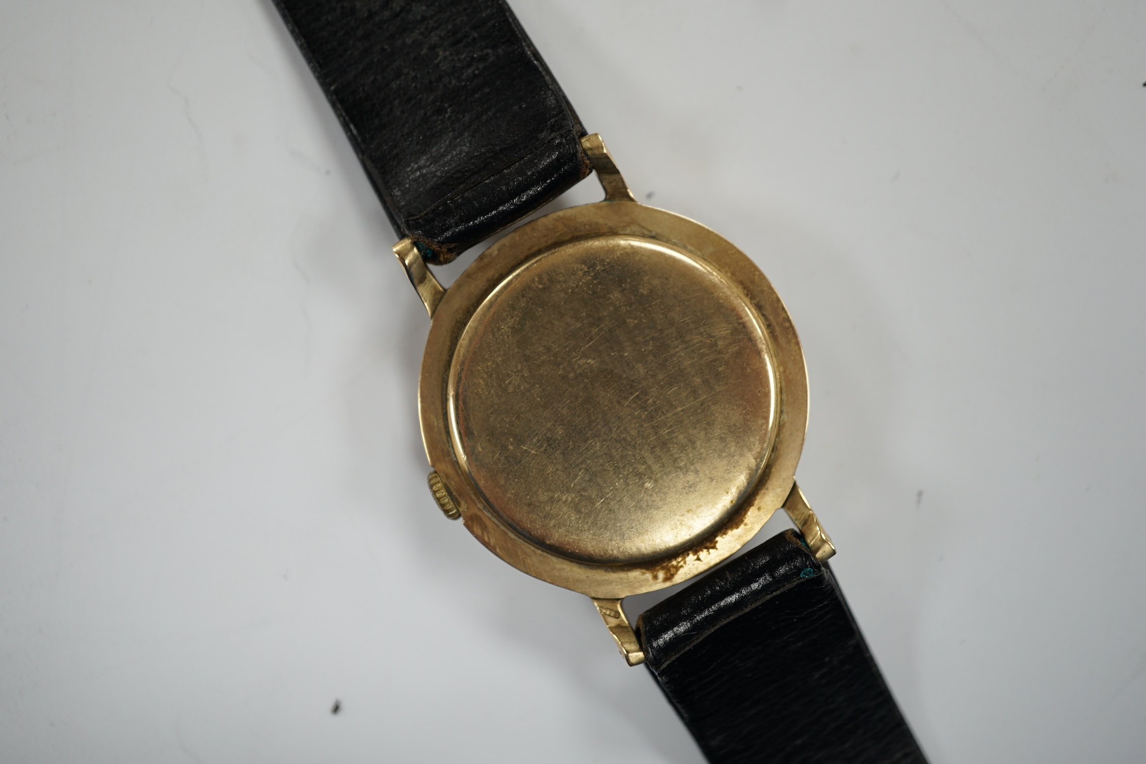 A gentleman's Swiss 9ct gold Griffon manual wind wrist watch, on a leather strap, case diameter 33mm.